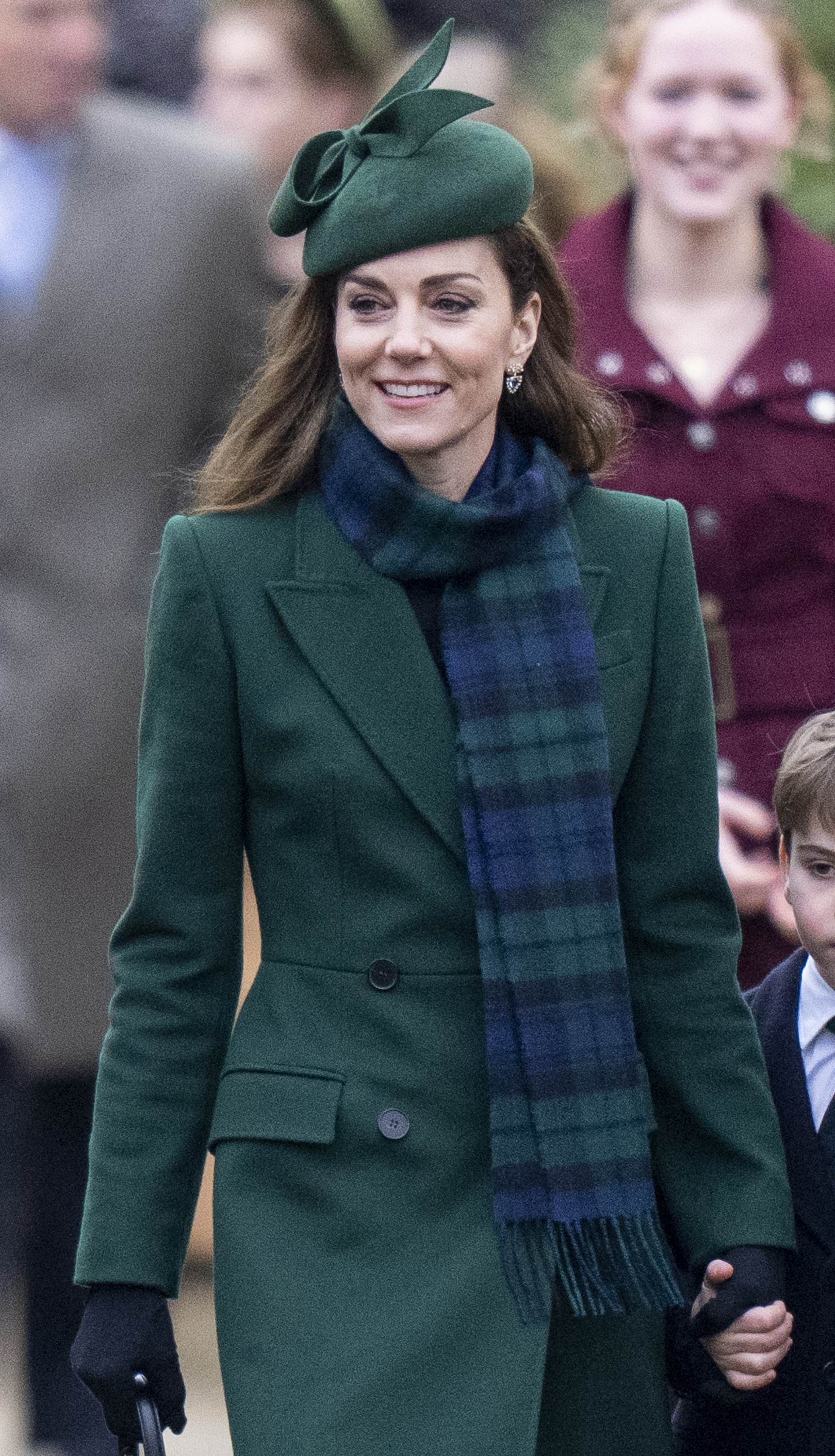 Kate Middleton wearing a green coat and plaid scarf
