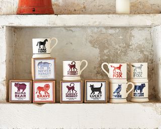 animal printed coffee mugs on wall shelves