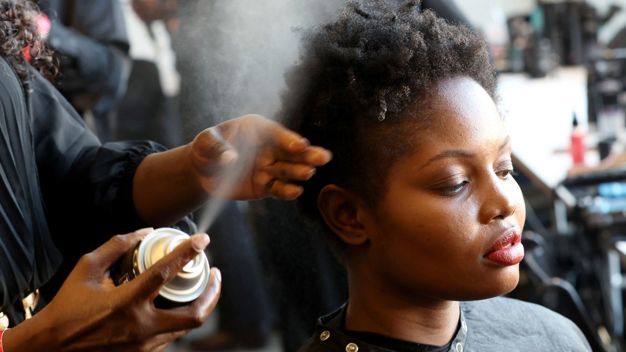 A model having her hair hairsprayed