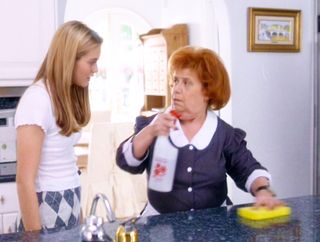 Cher Horowitz (Alicia Silverstone) wearing a white baby-t while talking to Aida Linares (as Lucy), the maid in Clueless
