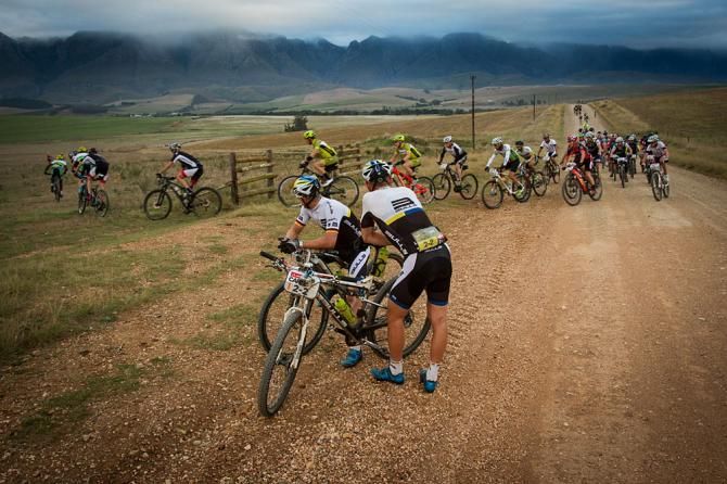 Team Bulls1 look on as the race continues after Karl Platt drops out of stage 4