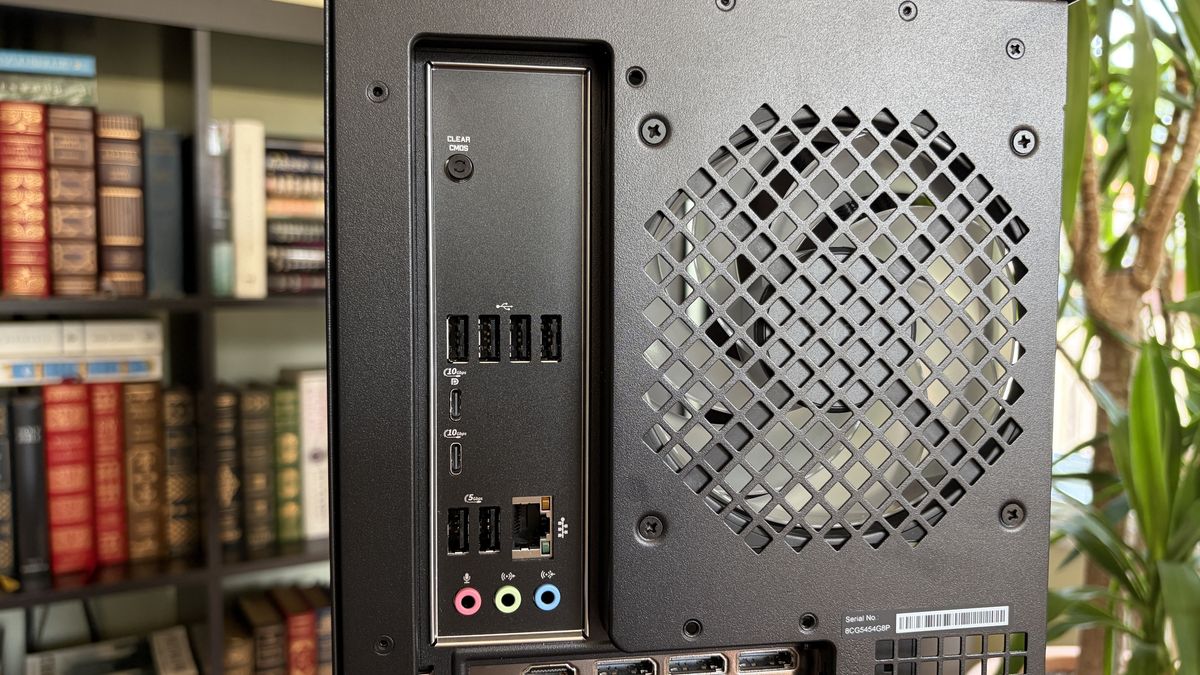 Rear view of an Omen Max 45L computer tower with multiple USB ports, an Ethernet port, audio jacks, and a ventilation grille, set against a blurred bookshelf background.