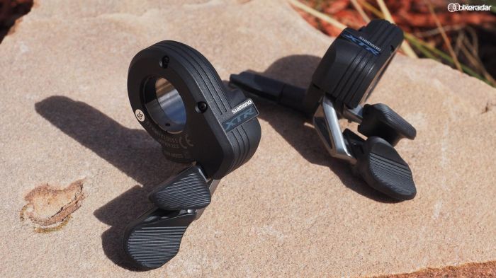 The XTR Di2 'Firebolt' shifters use a rotary motion instead of Shimano's usual pivoting arrangement. The textured pads provide a surprising amount of grip for your thumbs