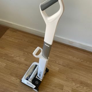 Gtech Airram Platinum standing on hardwood floors