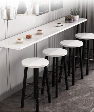 A wall mounted breakfast bar with stools