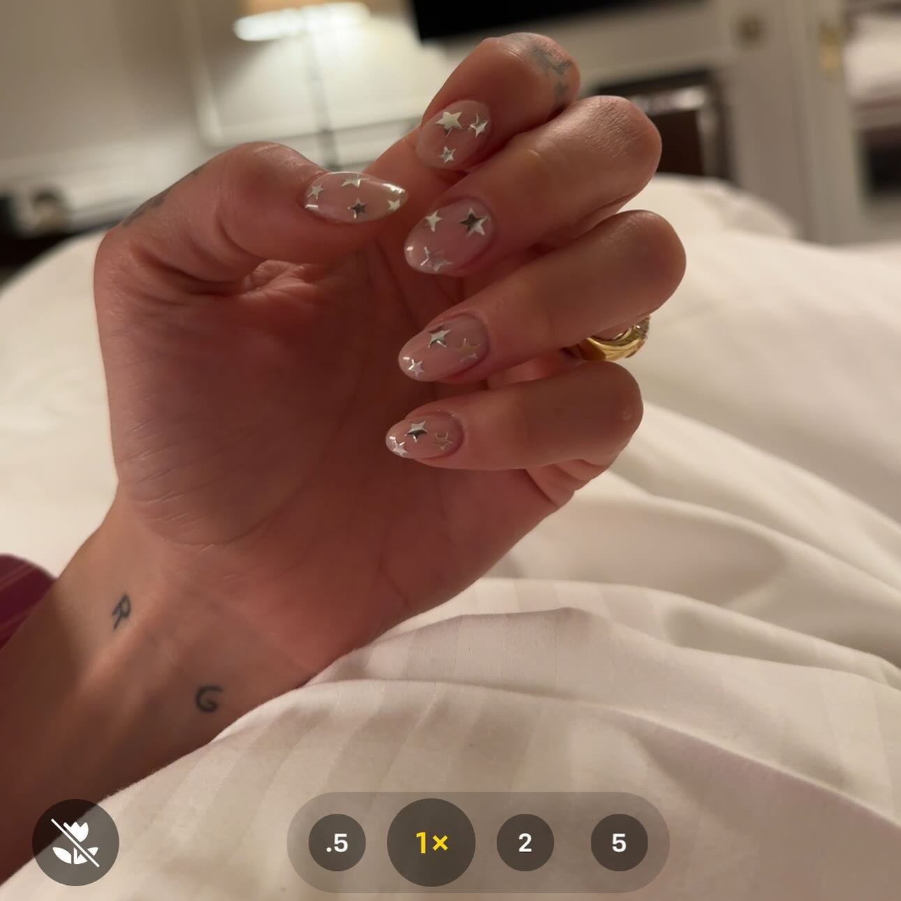 A close-up photo of Dua Lipa's milky star manicure