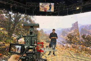 A Planar VR screen with a director in front of a virtual outdoor background.