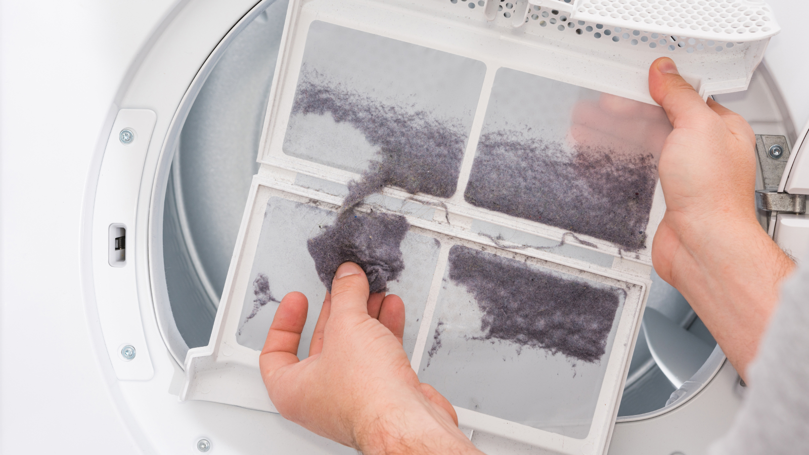 Man removing dryer lint from trap