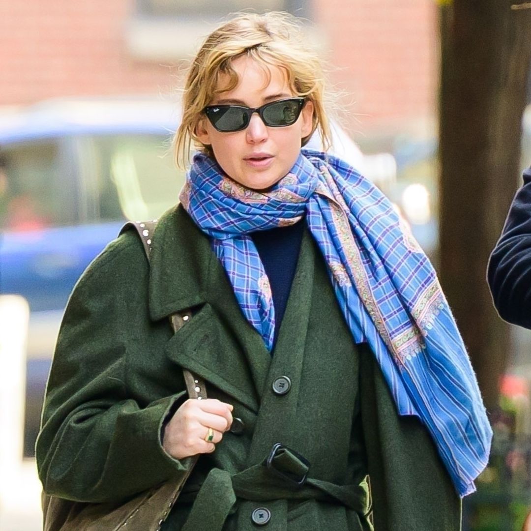 Jennifer Lawrence went for a walk in a green The Row coat, red track pants, and hiking sneakers