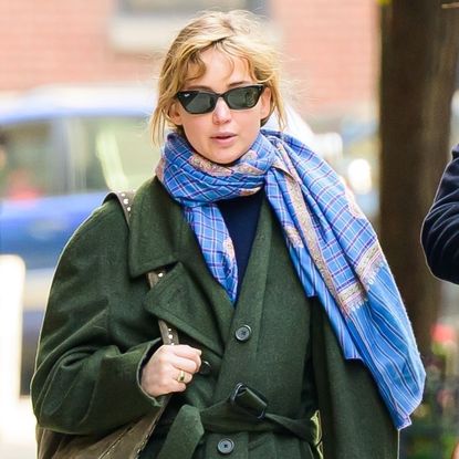 Jennifer Lawrence went for a walk in a green The Row coat, red track pants, and hiking sneakers