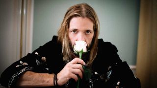 Taylor Hawkins smelling a white rose
