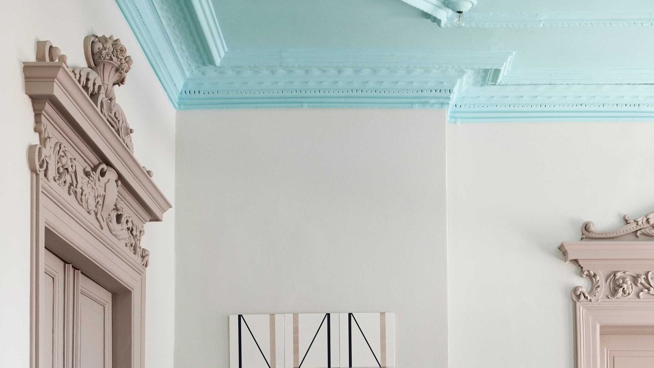 a grand room with a light blue painted ceiling