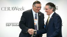 TotalEnergies CEO Patrick Pouyann&eacute; shakes hands with Interior Secretary Doug Burgum after signing an agreement during 2026 CERAWeek by S&P Global energy conference in Houston