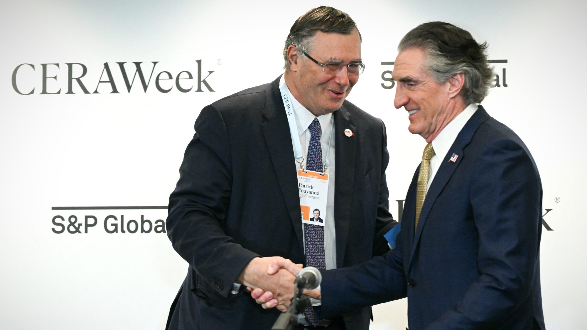 TotalEnergies CEO Patrick Pouyann&eacute; shakes hands with Interior Secretary Doug Burgum after signing an agreement during 2026 CERAWeek by S&amp;P Global energy conference in Houston