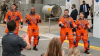 The Artemis Crew walk out of the Neil A. Armstrong Operations and Checkout Building ahead of the mission's launch.