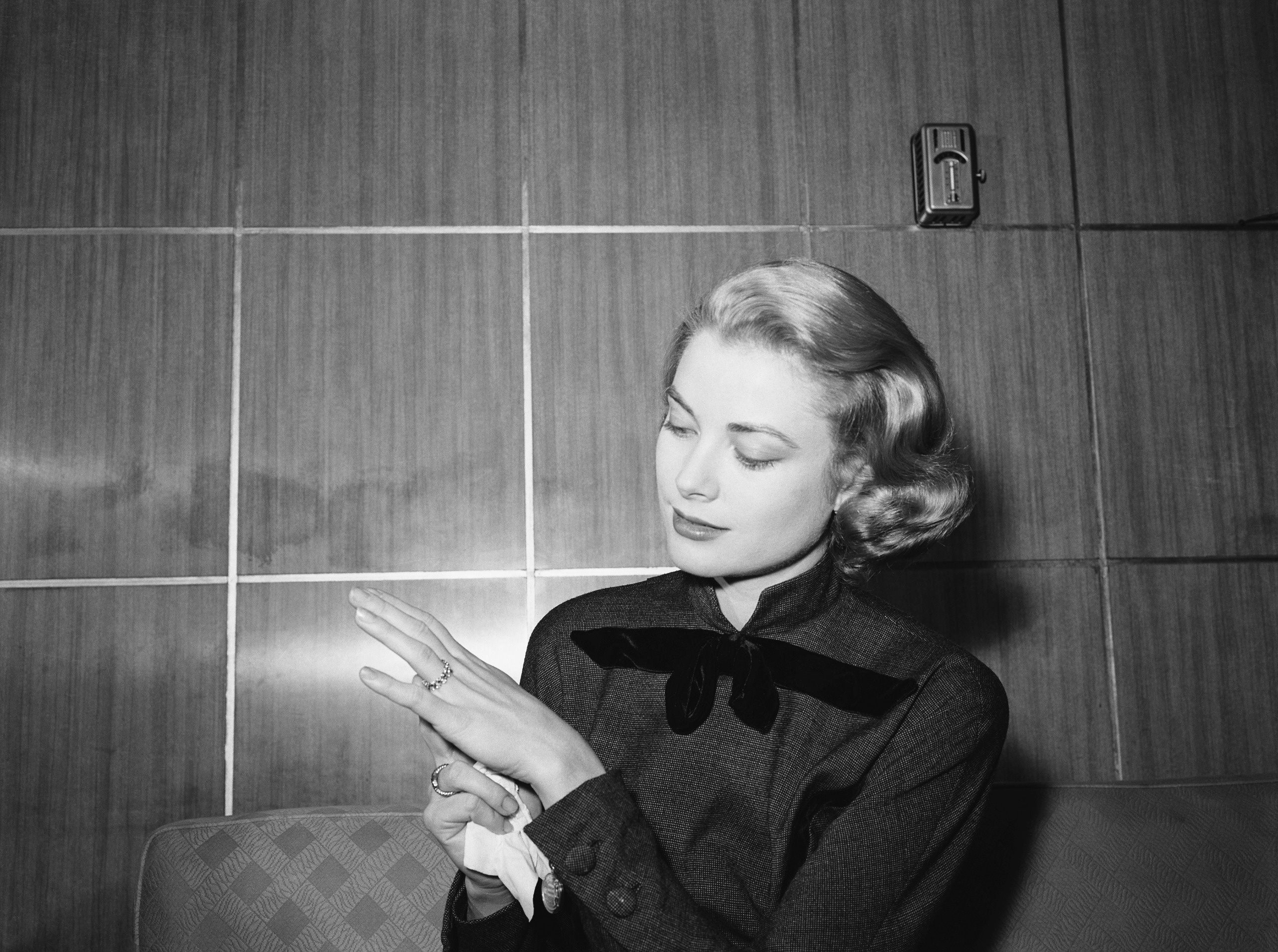 Grace Kelly looking down at her engagement ring