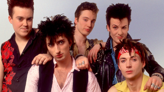 Portrait of the British rock group Flesh For Lulu as they pose backstage at the Riviera Theater, Chicago, Illinois, February 13, 1988. Pictured are, from left, Derek Greening, Rocco Barker, James Mitchell, Nick Marsh, and Kevin Mills.