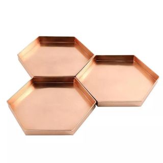 A set of hexagonal copper trays