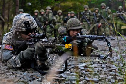 A U.S. soldier and a Japanese soldier participate in a training session together.