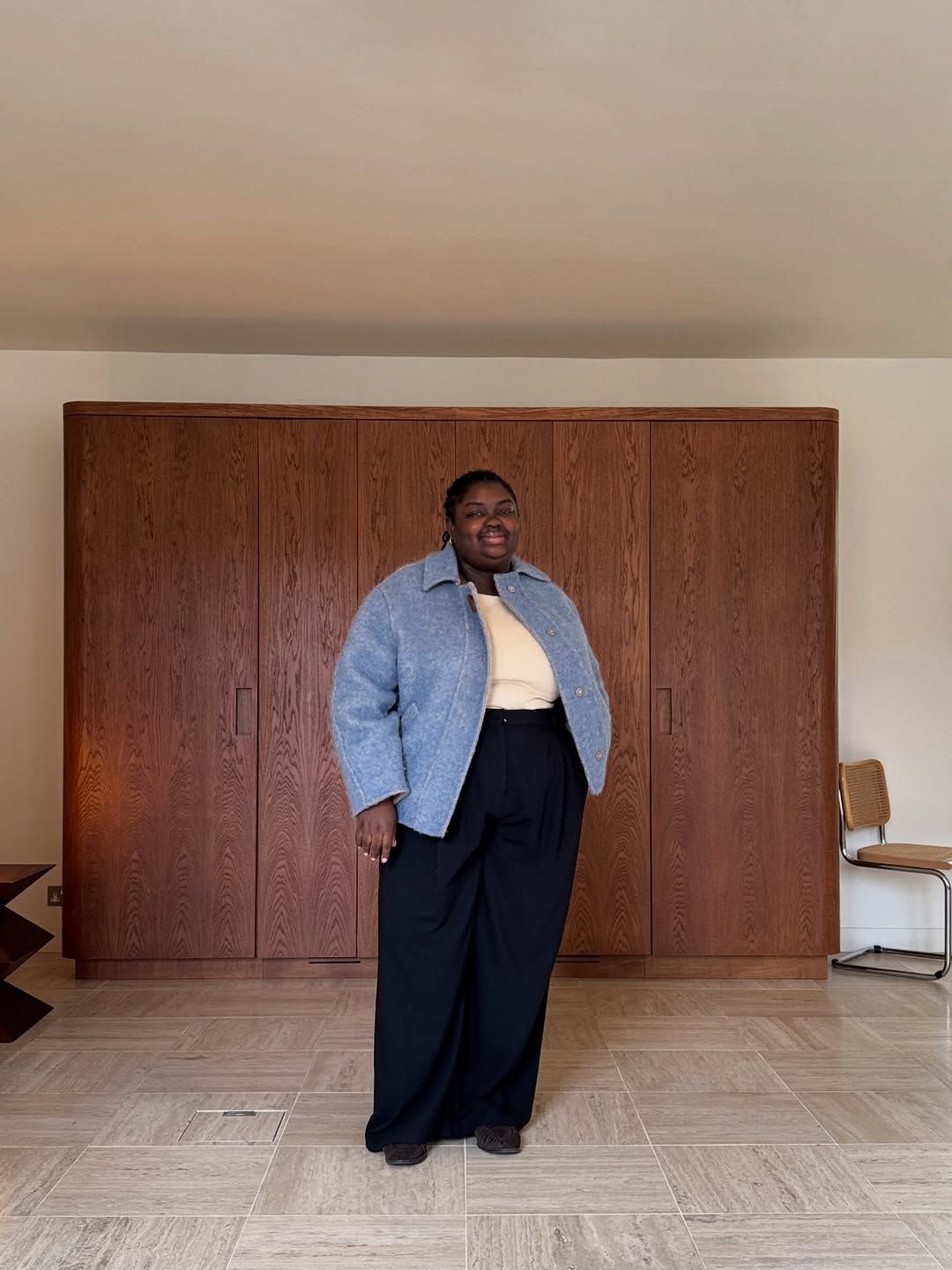 Abi in blue jacket and darted trousers