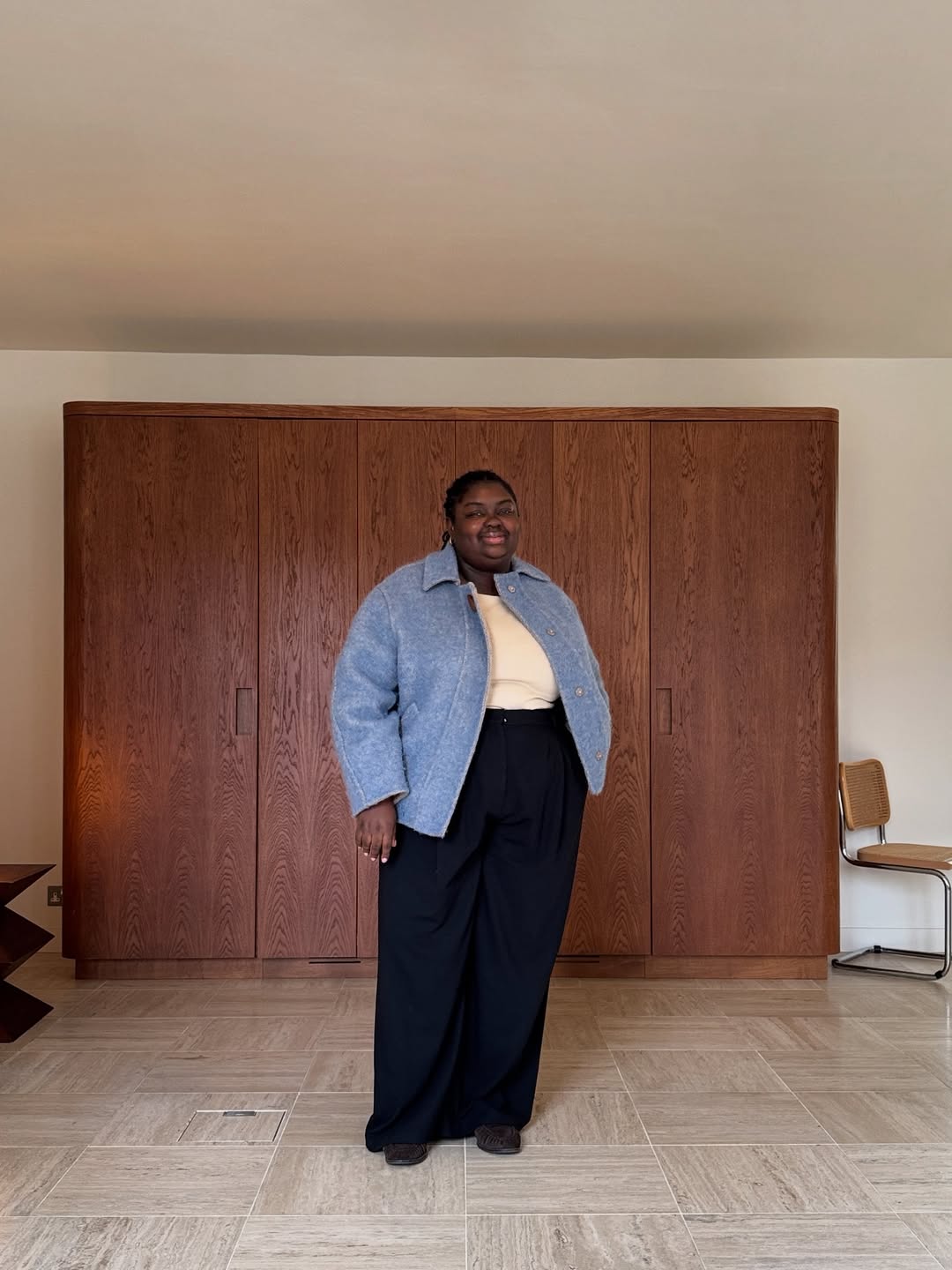 Abi in blue jacket and darted trousers