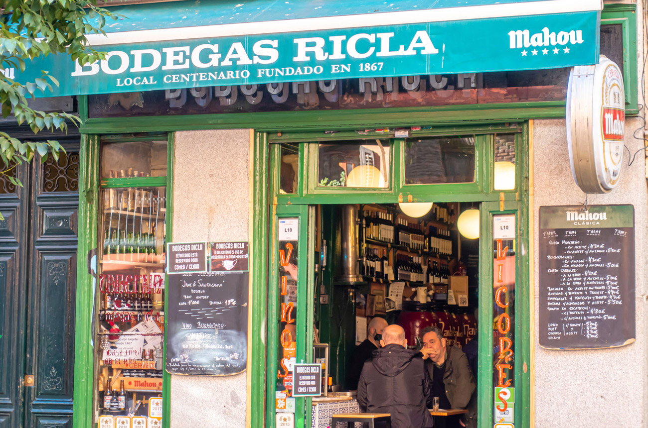 The front of a bar with people sitting at tables