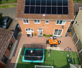 detached house viewed from above with solar panels