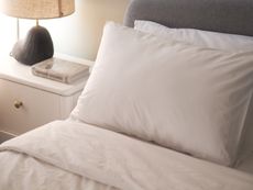 rise and fall white cotton bedding on a bed
