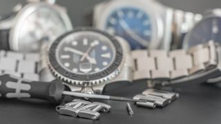 Three metal wristwatches with links removed ready to demonstrate how to remove a link from a watch