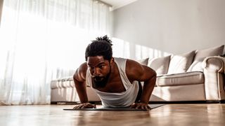 Man performs push-up at home