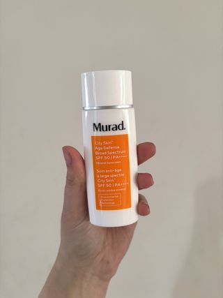 Mica Ricketts holding Murad City Skin Age Defense Broad Spectrum SPF 50 PA++++