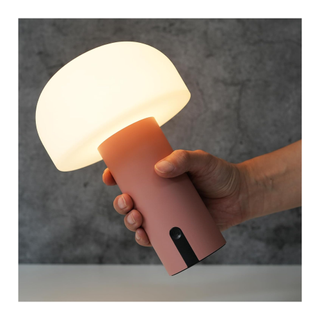 A portable pink mushroom table lamp