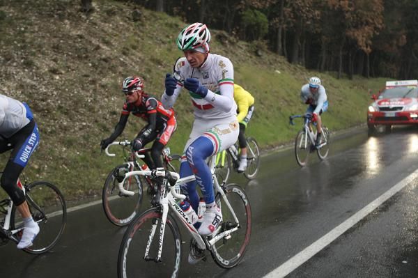 Pozzato clears off his glasses as the rain comes down.