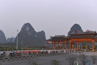 The peloton passes through a highway toll structure at the last edition of the Tour of Guangxi held in 2019