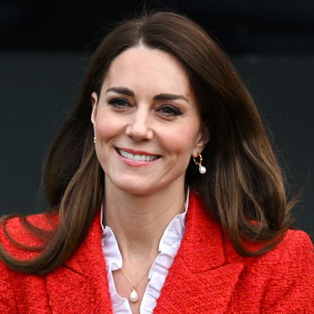 Princess Kate wearing a red blazer and smiling 