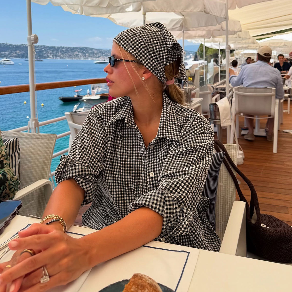 @sofiagrainge instagram photo at beachside restaurant in gingham shirt dress and gingham bandana