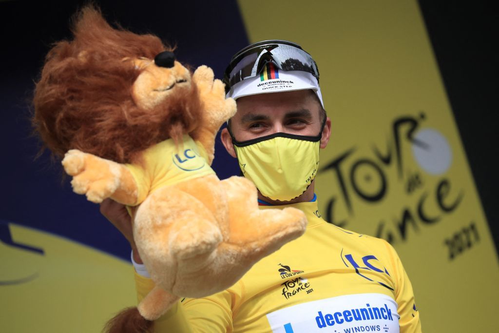 Team Deceuninck Quicksteps Julian Alaphilippe of France celebrates his overall leaders yellow jersey on the podium at the end of the 1st stage of the 108th edition of the Tour de France cycling race 197 km between Brest and Landerneau on June 26 2021 Photo by christophe petit tesson POOL AFP Photo by CHRISTOPHE PETIT TESSONPOOLAFP via Getty Images