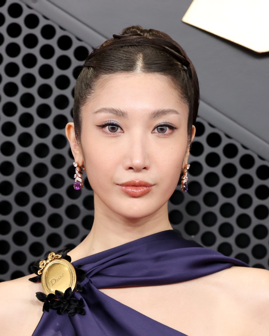 Ejae with an elegant updo and sleek cat eye at the 2026 Grammy Awards