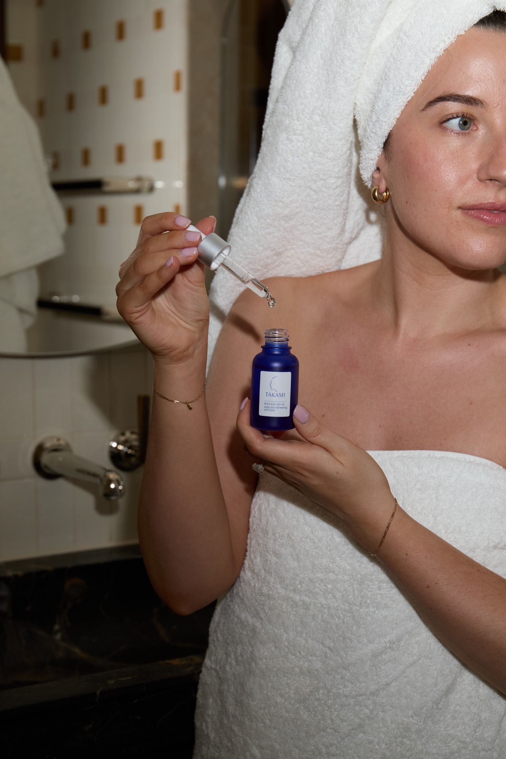Who What Wear UK deputy beauty editor Grace Lindsay holding a serum from Takami
