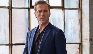 Billions Damian Lewis suited in front of a window