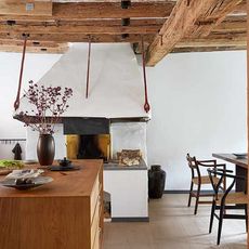 kitchen with dining table blacksmiths fire and wooden beams flower vase