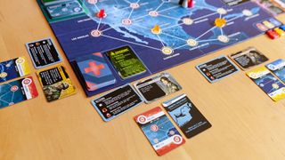 Pandemic Hot Zone North America game partway through playing, focusing on one player's cards