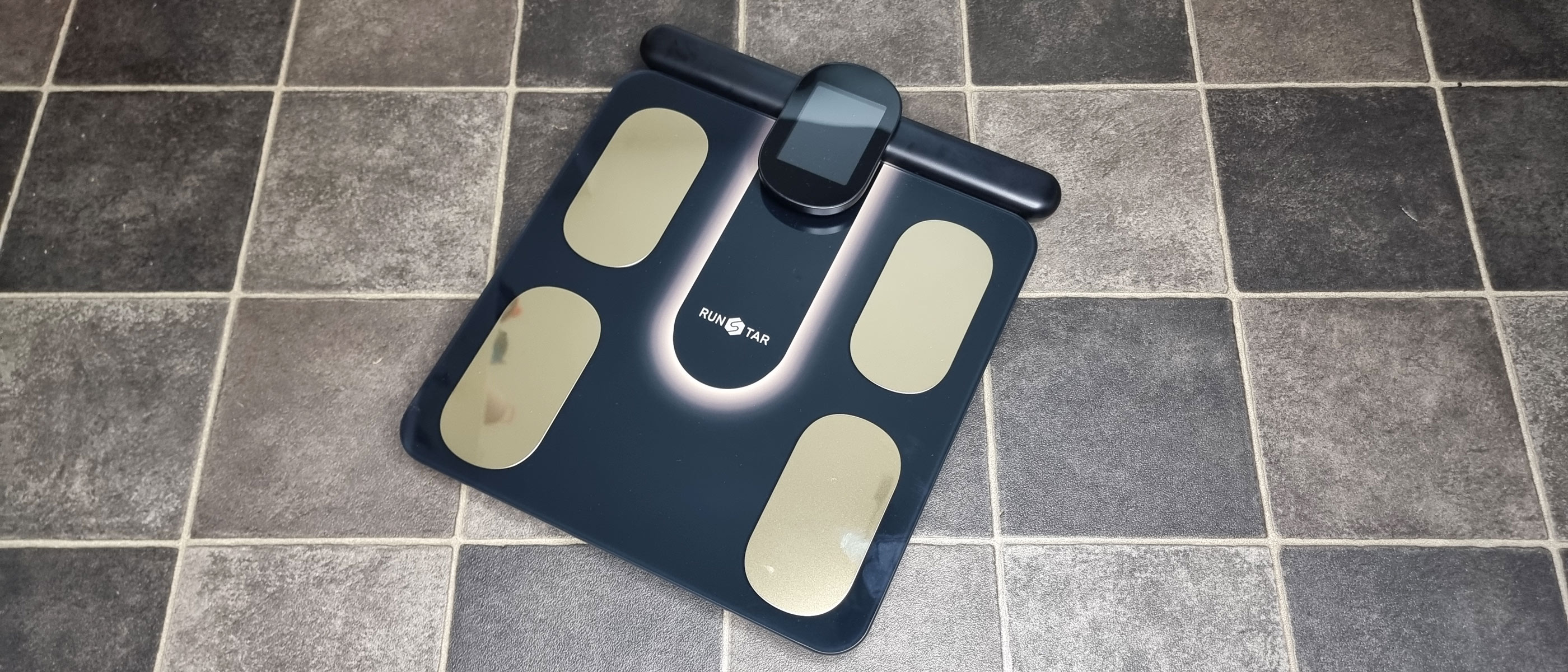 The RunStar 8E SmartScan Pro body fat scale on a bathroom floor