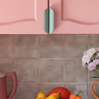 pink kitchen with painted cabinets