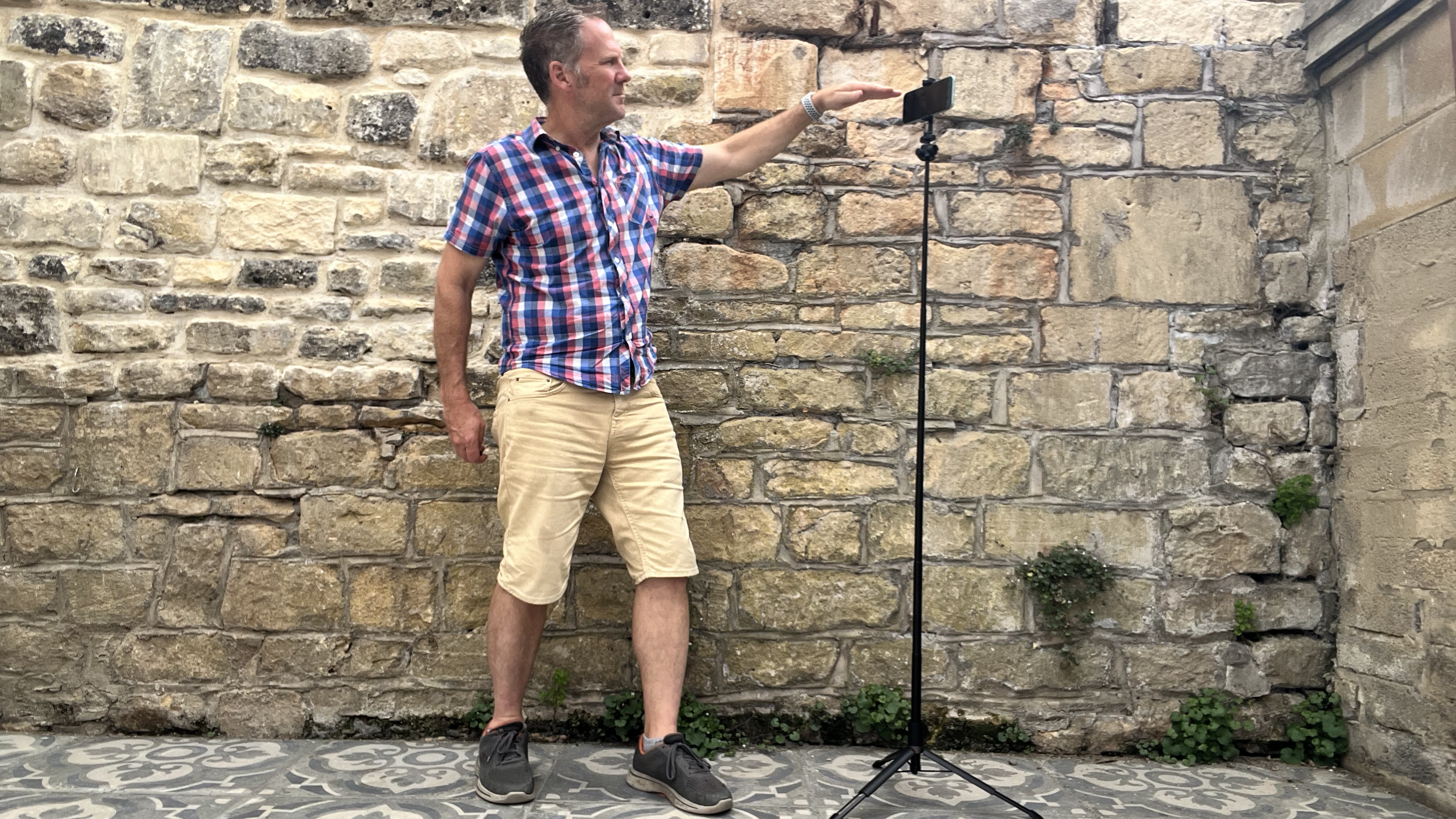 Man next to KraftGeek Variety Tripod supporting phone and light