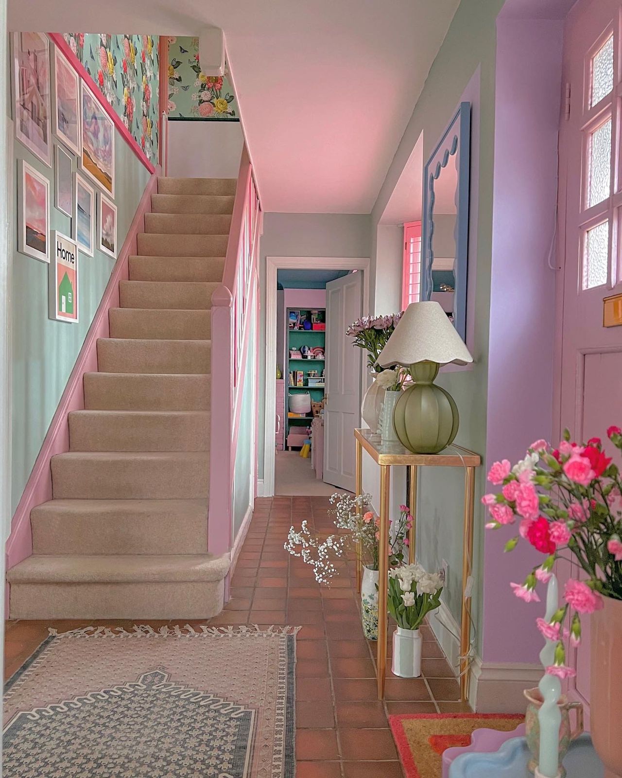 Hallway and landing of house given 'barbie makeover' with staircase leading upstairs