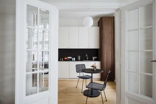 Small white apartment kitchen with dining table