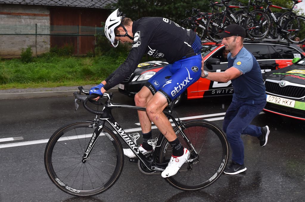 Pieter Serry gets a push from the team mechanic to get going again