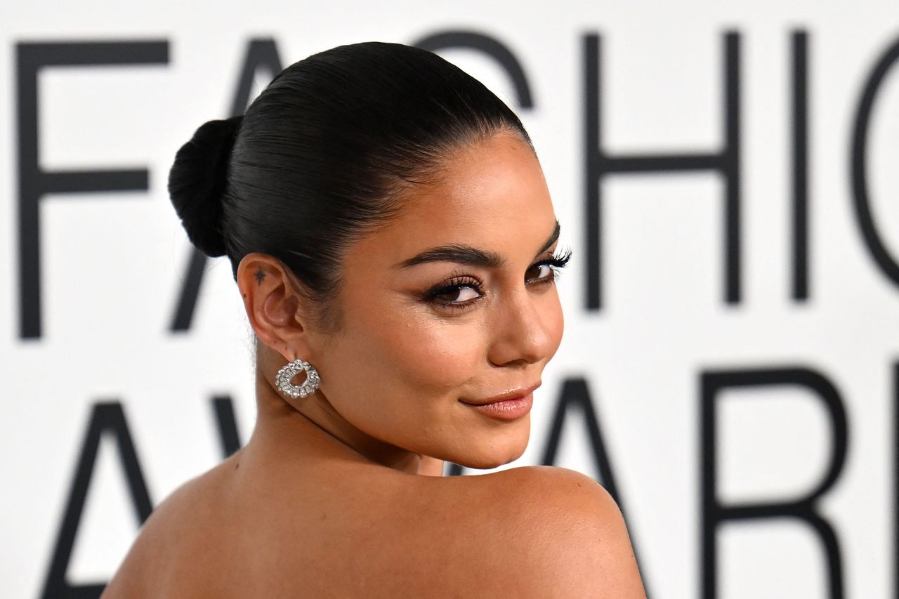 A headshot of Vanessa Hudgens looking over her shoulder