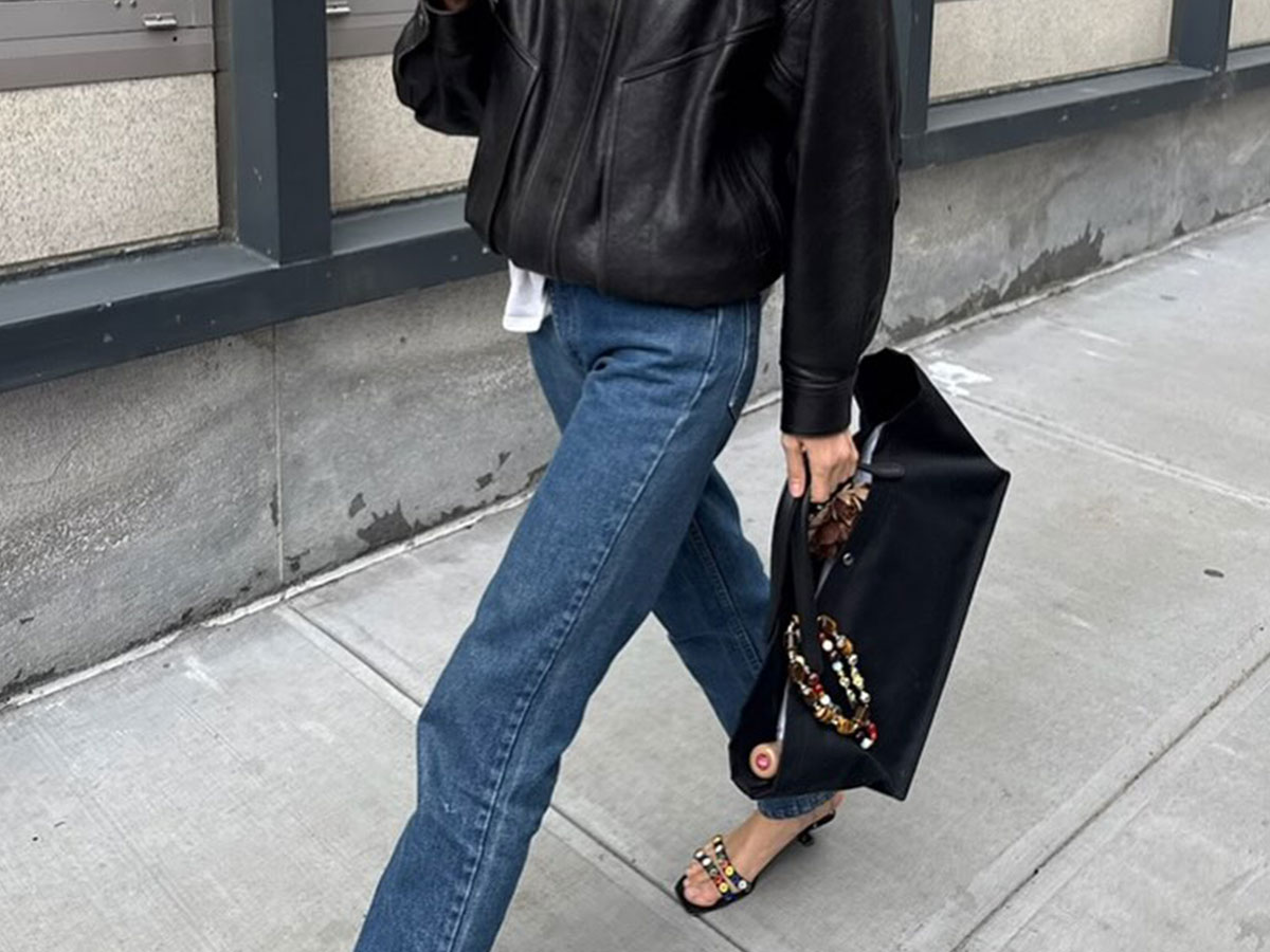 @courtneygrow outfit black leather jacket, blue jeans, the row idaho bag with charm